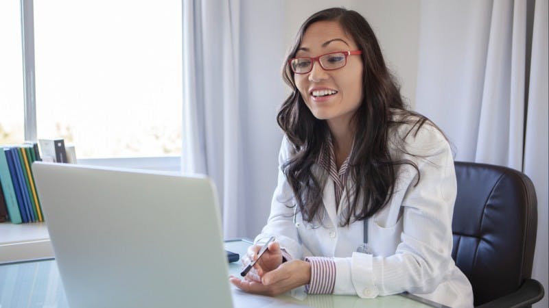 Young female doctor doing teleconference